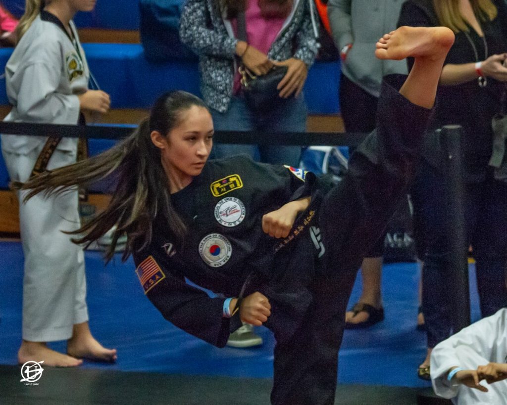 close up of young woman competing in tae kwon do tournament